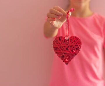 Girl holds heart-shaped jewelry concept of love valentine's day